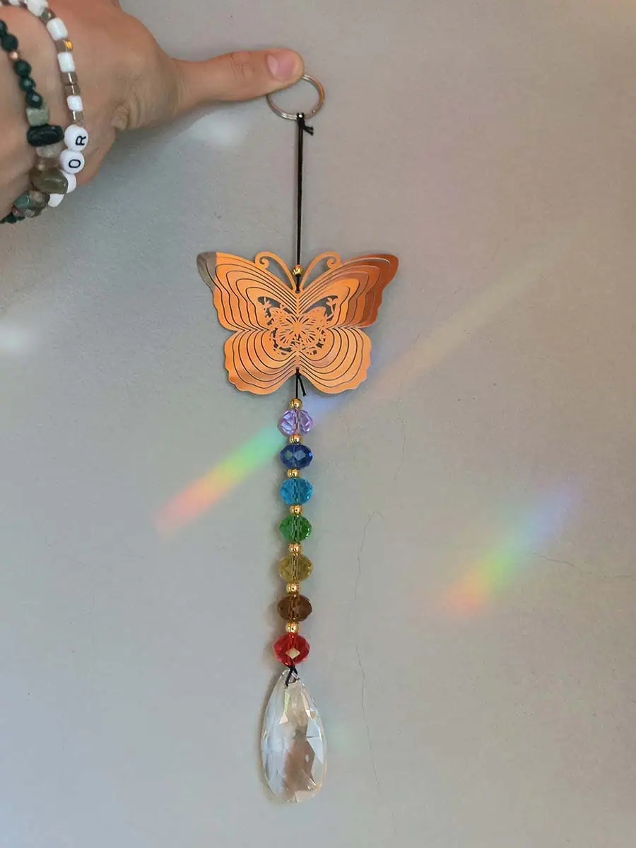 Atrapasol de acero inoxidable con mariposa y remolino decorativo