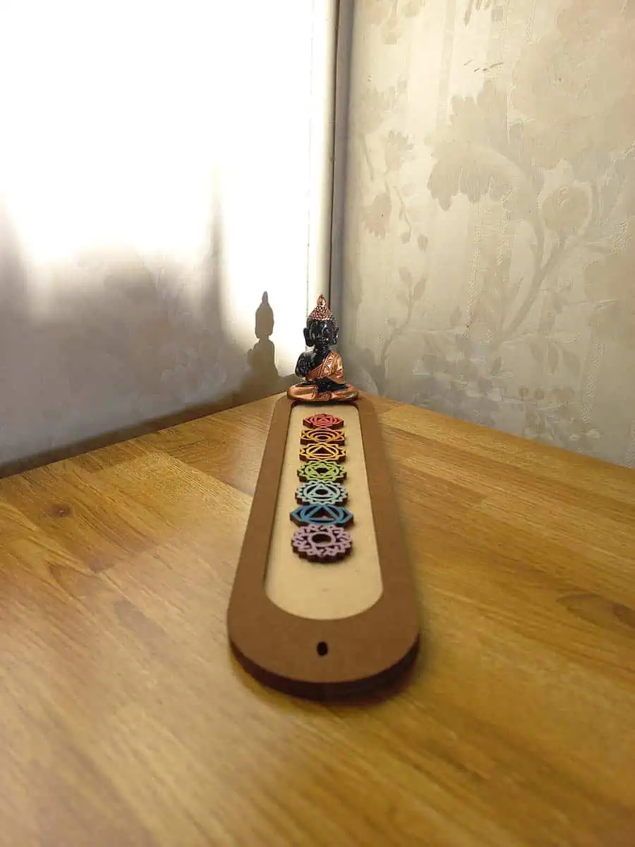 imagen de un portasahumerio de madera lindo con los 7 chakras y un buidta o ganesha